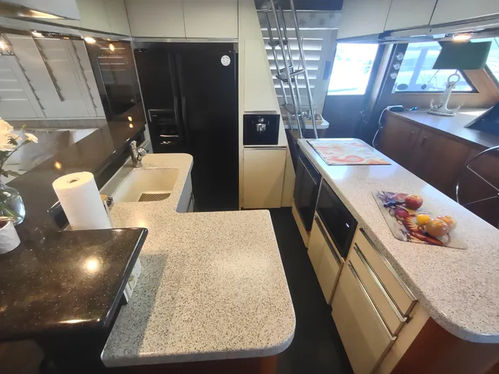  Yacht Photos Pics Interior of 1988 Hatteras 60 Motor Yacht kitchen with modern appliances and countertops.