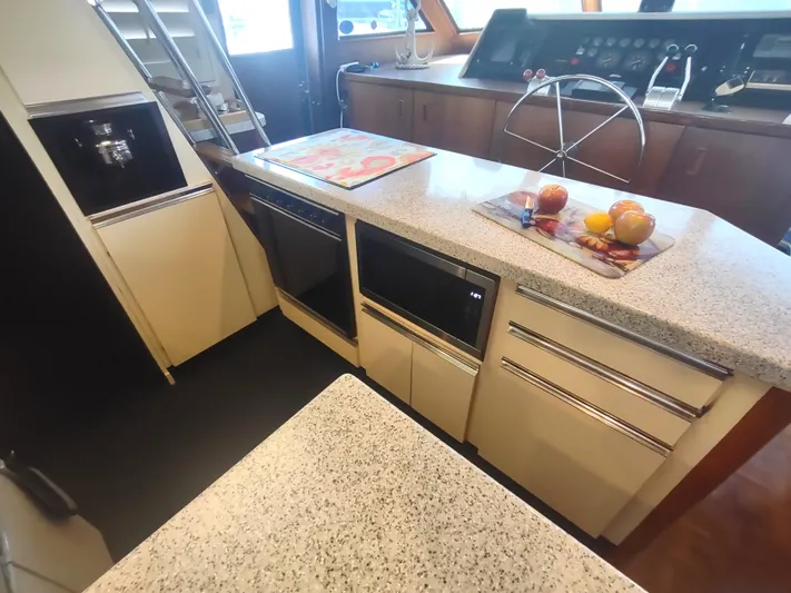  Yacht Photos Pics 1988 Hatteras 60 Motor Yacht kitchen with modern appliances and sleek countertops.