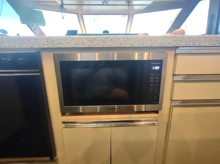  Yacht Photos Pics Microwave in 1988 Hatteras 60 Motor Yacht kitchen with modern cabinetry.