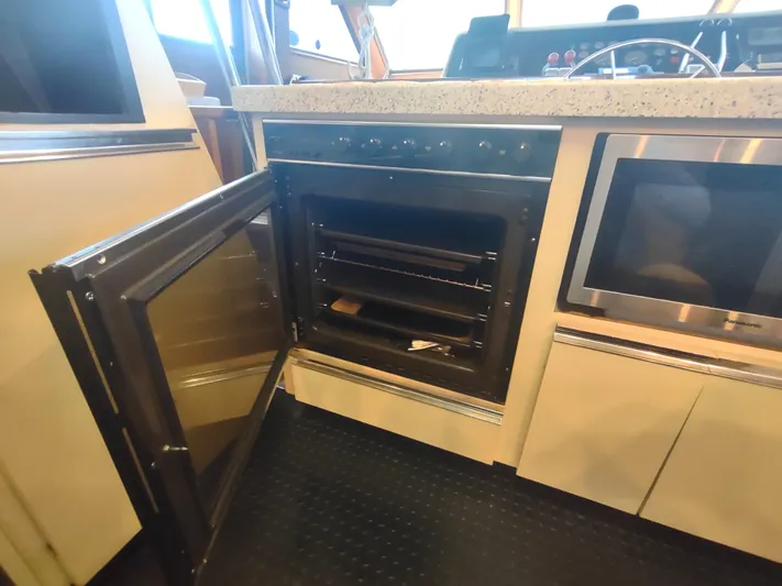  Yacht Photos Pics 1988 Hatteras 60 Motor Yacht kitchen with open oven and microwave.