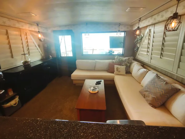  Yacht Photos Pics Cozy interior of 1988 Hatteras 60 Motor Yacht with plush seating and warm lighting.