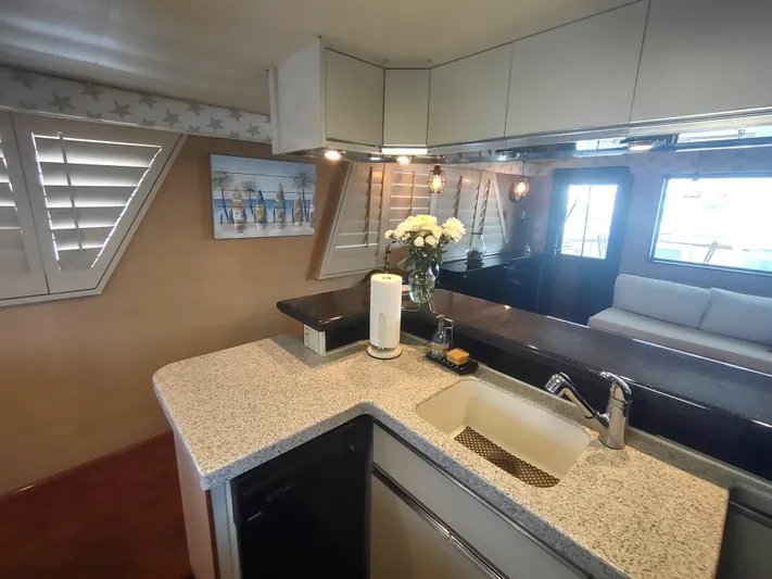  Yacht Photos Pics Interior of 1988 Hatteras 60 Motor Yacht with modern kitchen and cozy seating area.