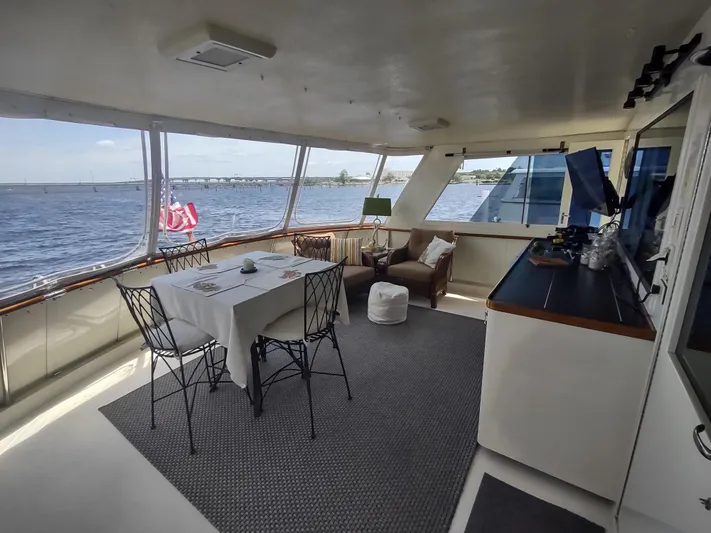  Yacht Photos Pics Spacious interior of 1988 Hatteras 60 Motor Yacht with dining area and scenic views.