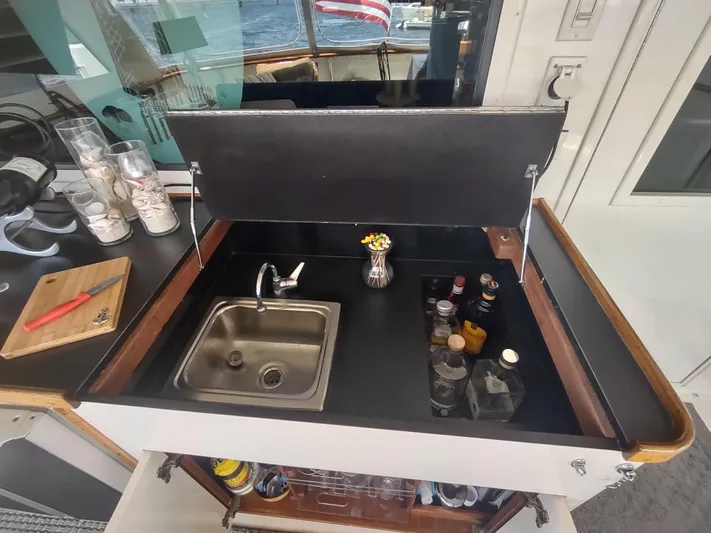  Yacht Photos Pics 1988 Hatteras 60 Motor Yacht bar area with sink and assorted bottles.