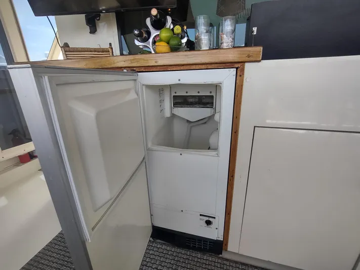  Yacht Photos Pics Open ice maker on 1988 Hatteras 60 Motor Yacht with countertop and fruit display.