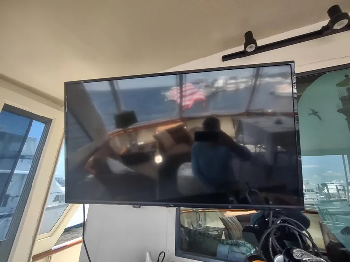  Yacht Photos Pics Reflection on TV screen inside 1988 Hatteras 60 Motor Yacht cabin.