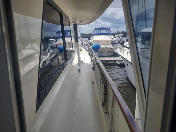  Yacht Photos Pics 1988 Hatteras 60 Motor Yacht docked, side view with marina background.