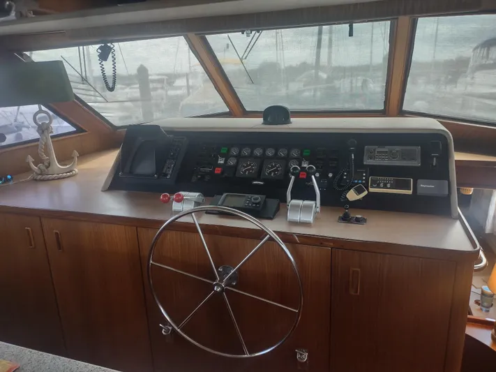  Yacht Photos Pics Helm of 1988 Hatteras 60 Motor Yacht with steering wheel and control panel.
