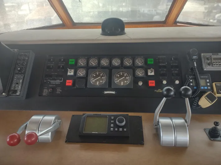  Yacht Photos Pics Control panel of a 1988 Hatteras 60 Motor Yacht with gauges and levers.