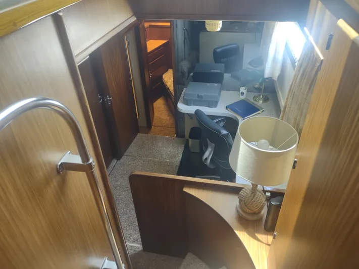  Yacht Photos Pics Interior of 1988 Hatteras 60 Motor Yacht with wood paneling and cozy furnishings.