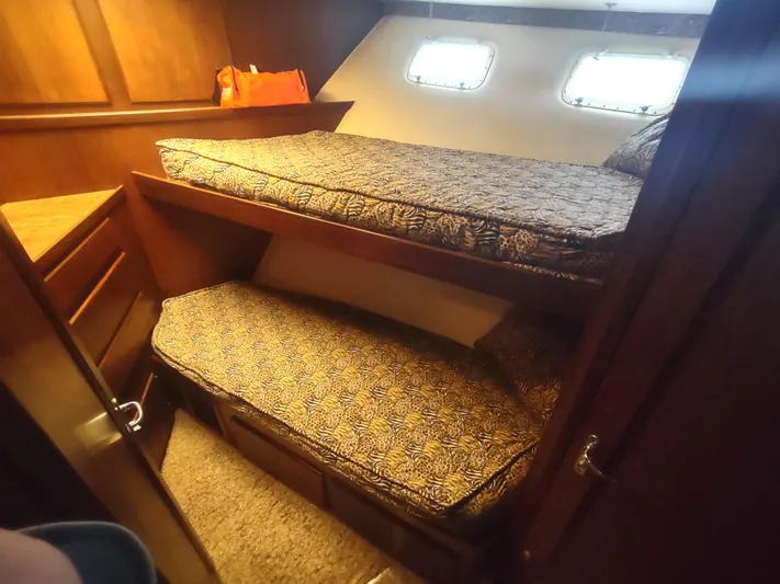  Yacht Photos Pics Cozy cabin interior of 1988 Hatteras 60 Motor Yacht with twin bunks.