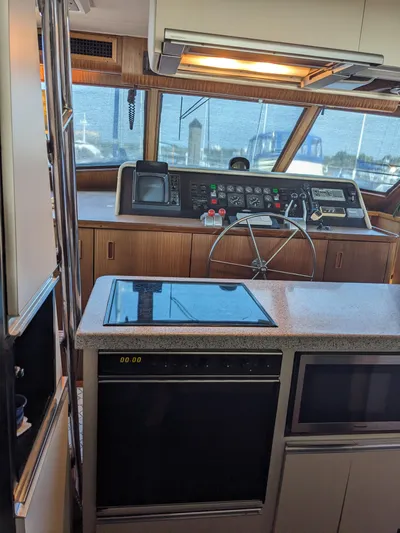 Yacht Photos Pics Interior of 1988 Hatteras 60 Motor Yacht helm with modern controls and steering wheel.