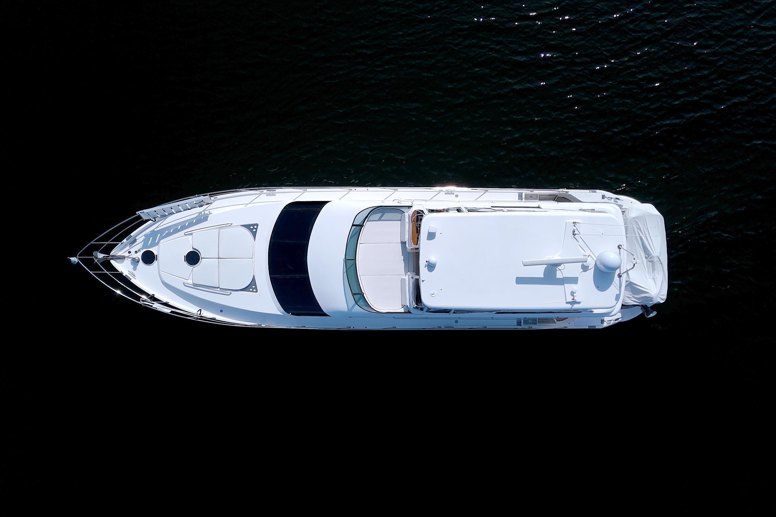 Top view of 2005 Neptunus 62 Flybridge yacht on dark water.