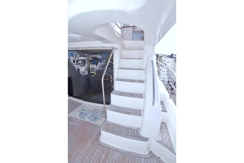 Bliss Yacht Photos Pics Staircase on 2005 Neptunus 62 Flybridge yacht with teak flooring and sleek design.