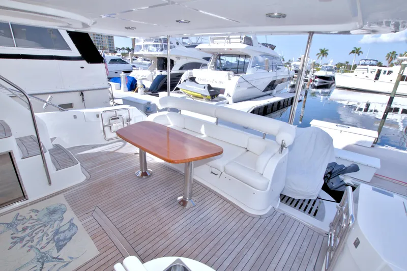 Bliss Yacht Photos Pics Luxurious 2005 Neptunus 62 Flybridge yacht with spacious deck and elegant seating area.