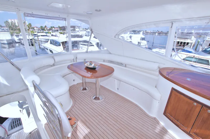 Bliss Yacht Photos Pics Luxurious 2005 Neptunus 62 Flybridge yacht interior with elegant seating and wooden accents.