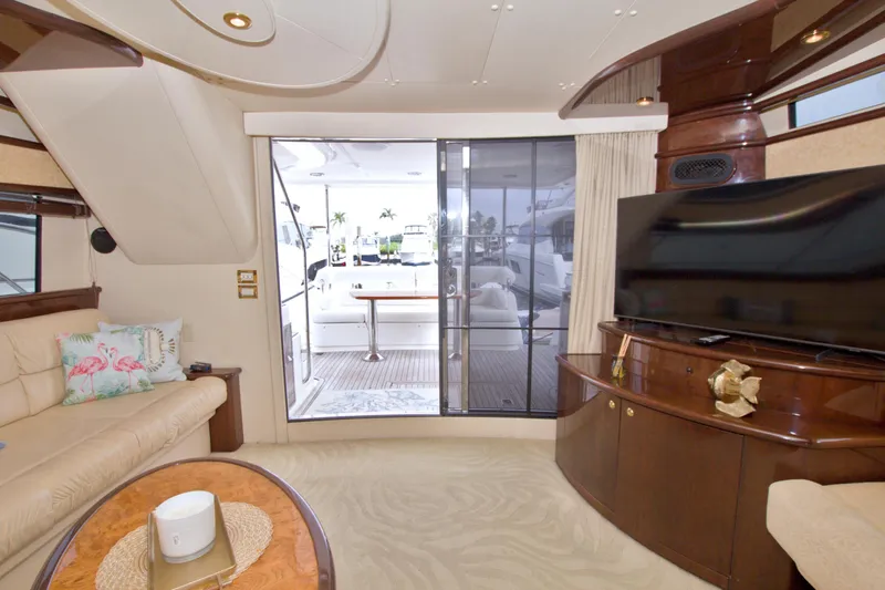 Bliss Yacht Photos Pics Luxurious interior of 2005 Neptunus 62 Flybridge yacht with elegant furnishings and large TV.