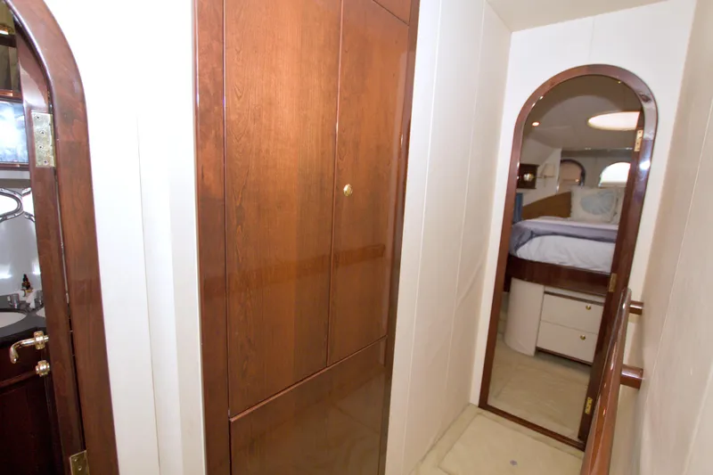 Bliss Yacht Photos Pics Luxurious interior hallway of 2005 Neptunus 62 Flybridge yacht with wooden cabinetry.