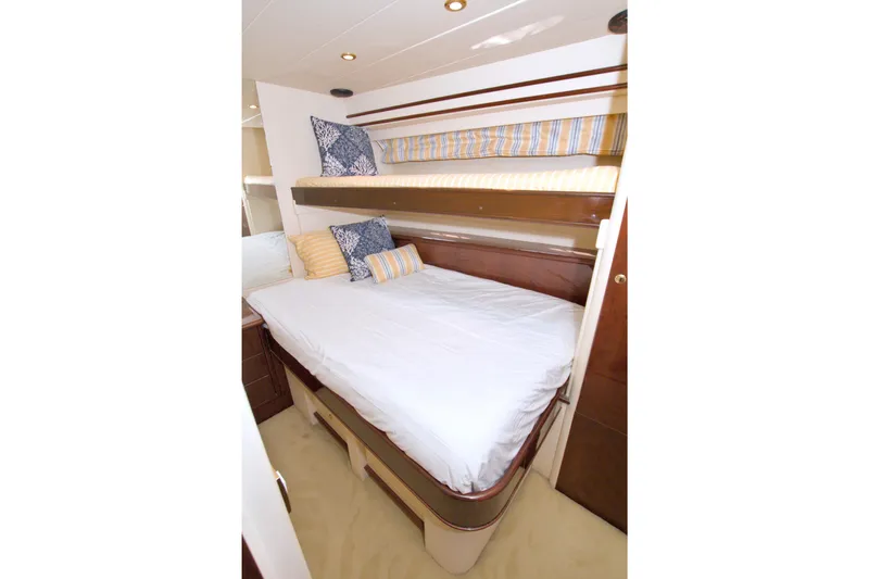 Bliss Yacht Photos Pics Luxurious cabin interior of 2005 Neptunus 62 Flybridge yacht with cozy bedding.