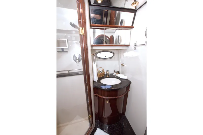Bliss Yacht Photos Pics Luxurious bathroom in 2005 Neptunus 62 Flybridge yacht with elegant wood cabinetry.