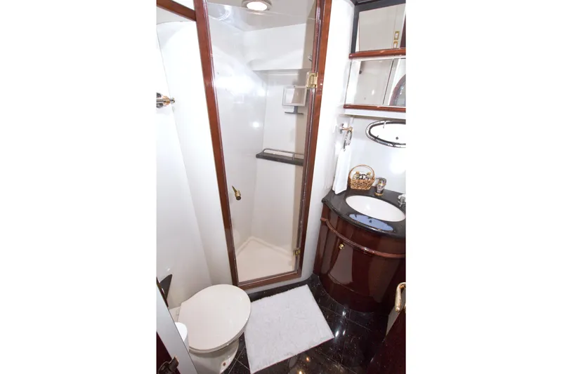 Bliss Yacht Photos Pics Luxurious bathroom in 2005 Neptunus 62 Flybridge yacht with shower and elegant fixtures.