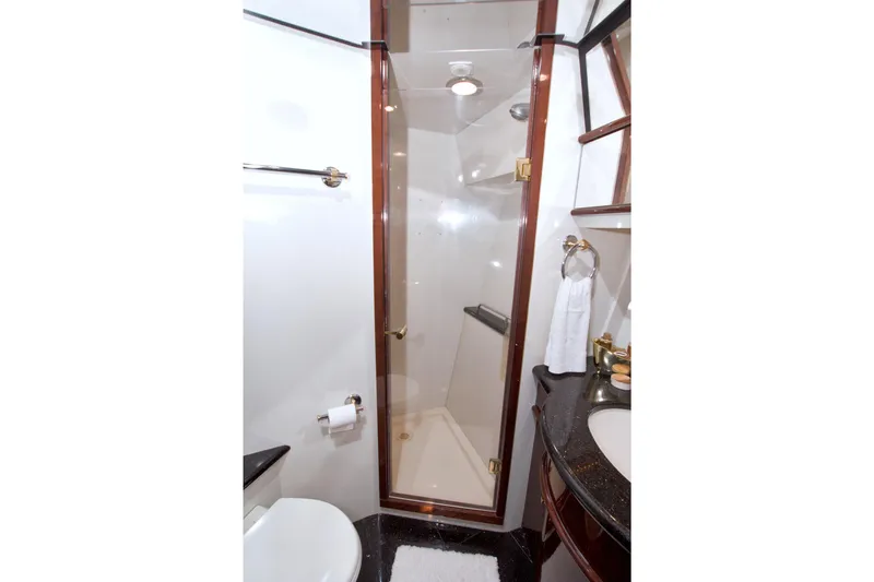 Bliss Yacht Photos Pics Luxurious bathroom in 2005 Neptunus 62 Flybridge yacht with glass shower and elegant fixtures.