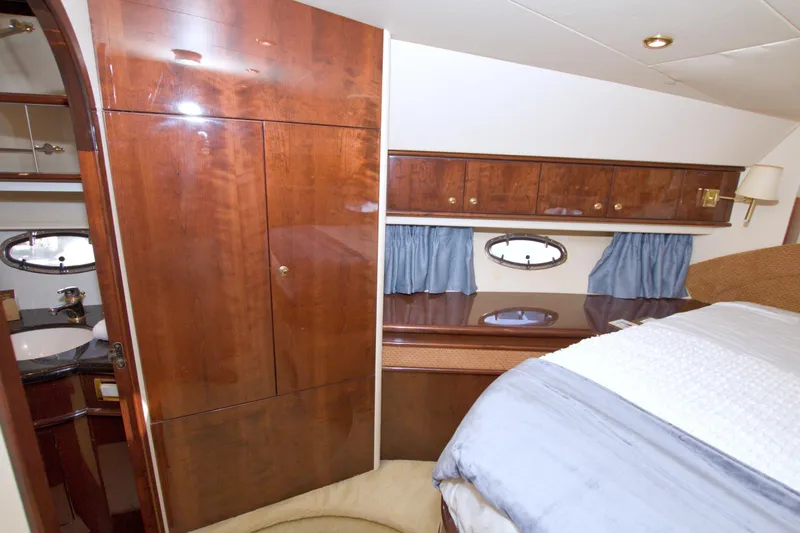 Bliss Yacht Photos Pics Luxurious cabin interior of 2005 Neptunus 62 Flybridge yacht with wood finishes.
