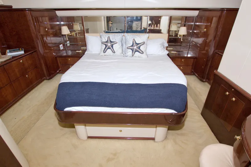 Bliss Yacht Photos Pics Luxurious bedroom interior of 2005 Neptunus 62 Flybridge yacht with elegant wood finishes.