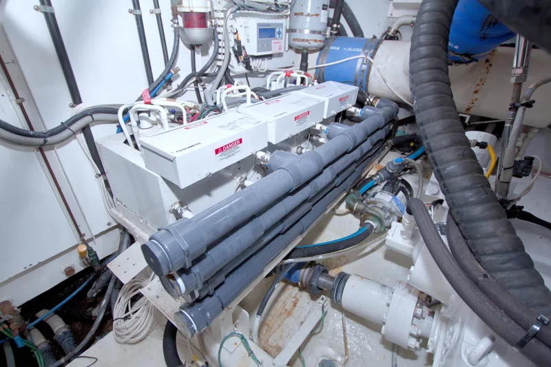 Bliss Yacht Photos Pics Engine room of 2005 Neptunus 62 Flybridge yacht with mechanical components and wiring.