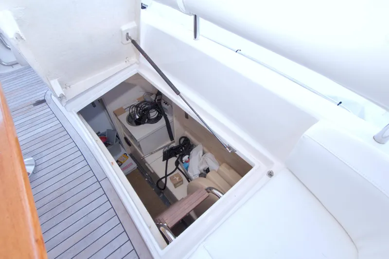 Bliss Yacht Photos Pics Storage compartment on 2005 Neptunus 62 Flybridge yacht, featuring organized cables and equipment.