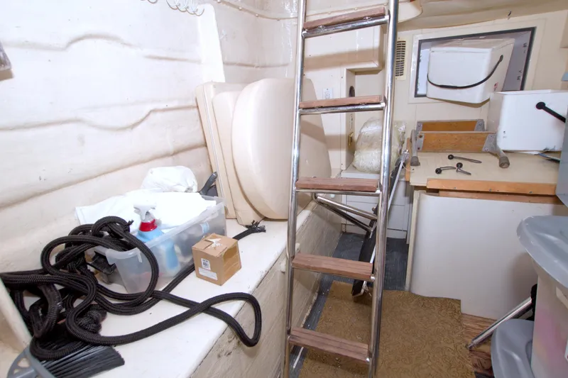 Bliss Yacht Photos Pics 2005 Neptunus 62 Flybridge interior with ladder, storage, and maintenance tools.