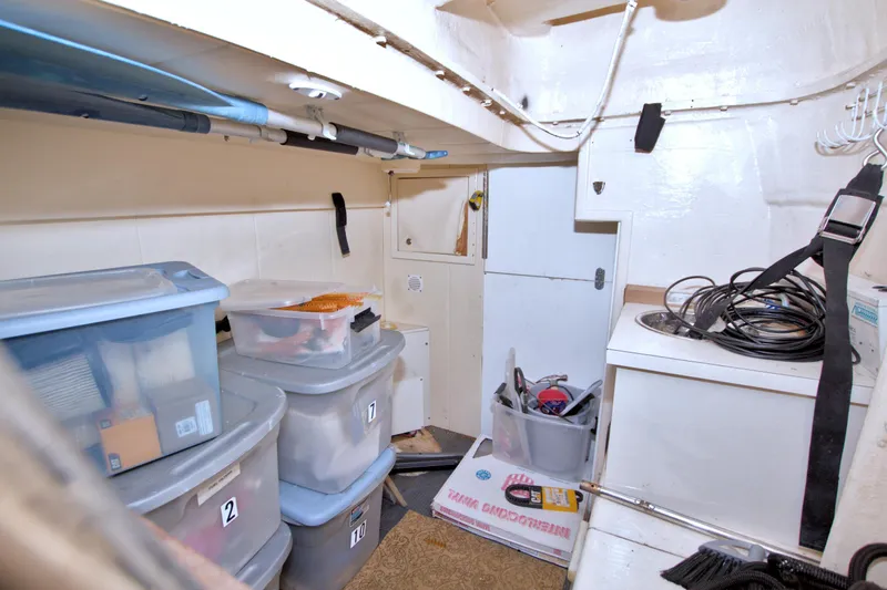 Bliss Yacht Photos Pics Storage area on 2005 Neptunus 62 Flybridge with organized plastic bins and equipment.
