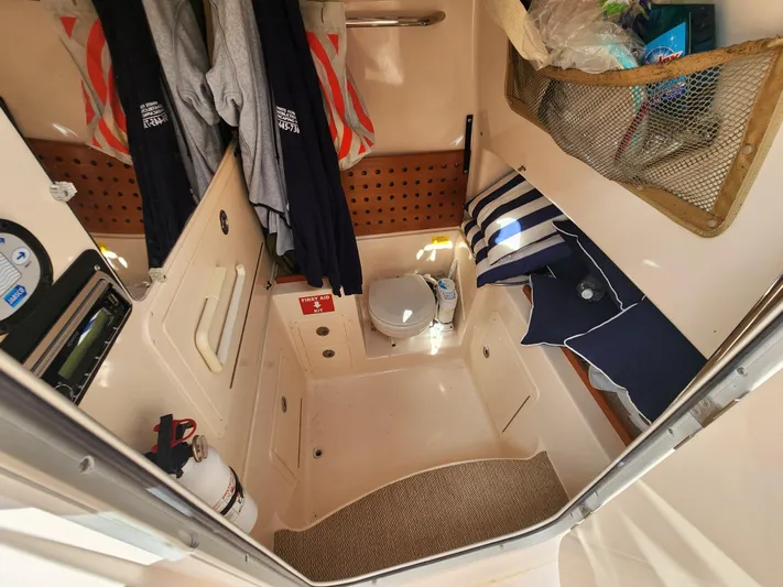  Yacht Photos Pics 2008 Grady-White 306 Bimini CC cabin interior with storage and toilet.