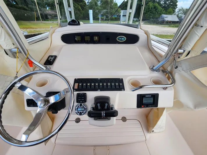  Yacht Photos Pics 2008 Grady-White 306 Bimini CC boat helm with steering wheel and control panel.