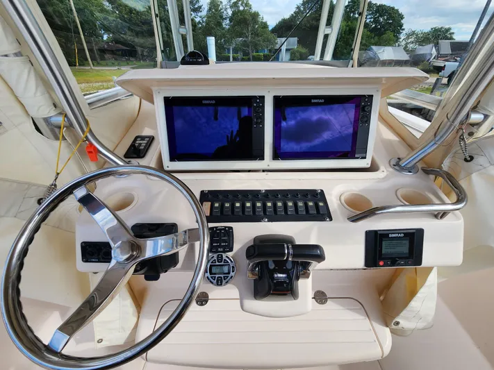  Yacht Photos Pics 2008 Grady-White 306 Bimini CC helm with dual Simrad displays and stainless steel steering wheel.