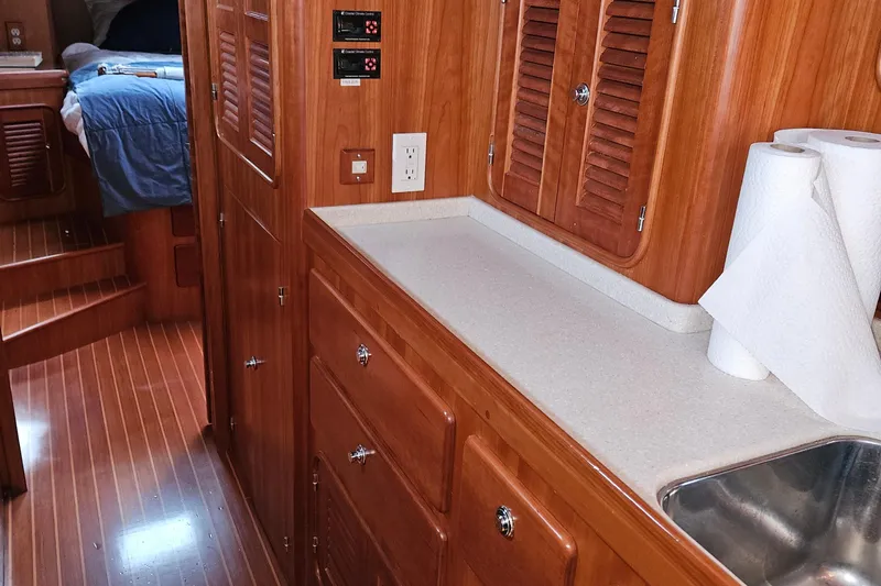 Providence Yacht Photos Pics Interior of 2013 Passport 470 Center Cockpit yacht with wooden cabinetry and countertop.