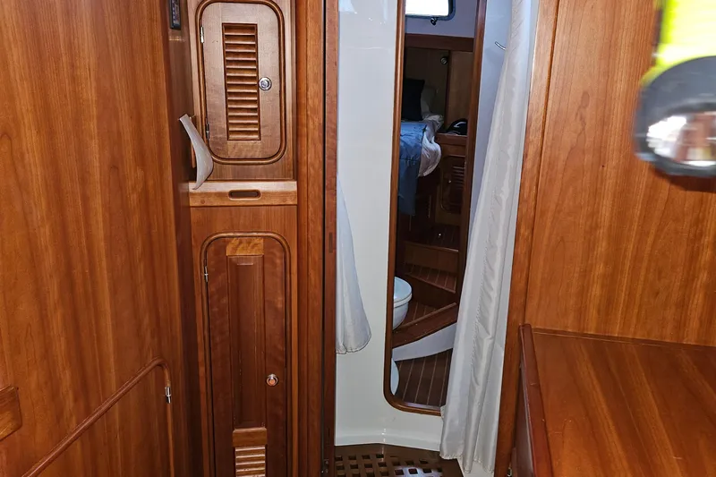 Providence Yacht Photos Pics Interior of 2013 Passport 470 Center Cockpit yacht with wooden cabinetry and mirror.