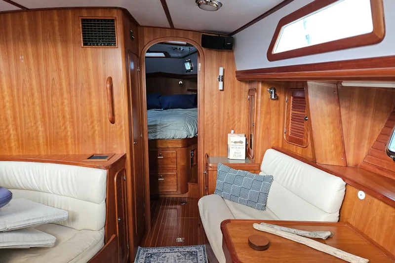 Providence Yacht Photos Pics Interior of 2013 Passport 470 Center Cockpit yacht with wood paneling and cozy seating area.