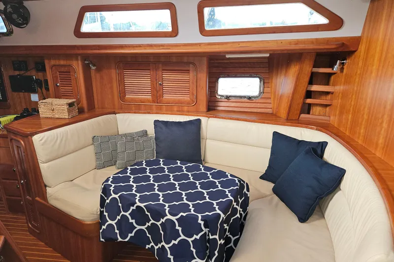 Providence Yacht Photos Pics Cozy interior of 2013 Passport 470 Center Cockpit with cushioned seating and nautical decor.
