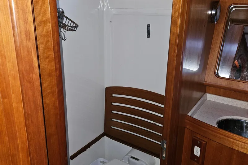 Providence Yacht Photos Pics Interior of 2013 Passport 470 Center Cockpit yacht bathroom with wooden accents and sink.