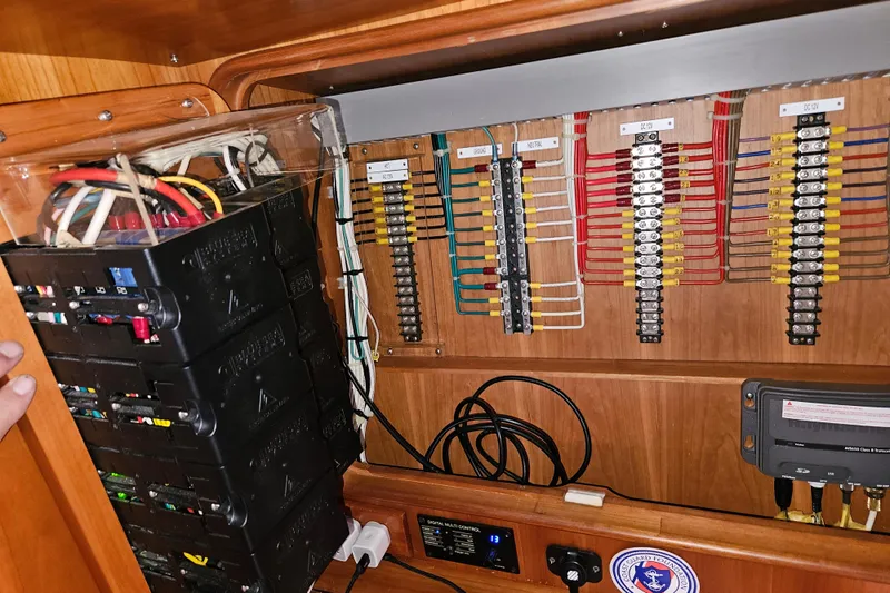 Providence Yacht Photos Pics Electrical panel inside 2013 Passport 470 Center Cockpit yacht, showcasing wiring and circuit breakers.