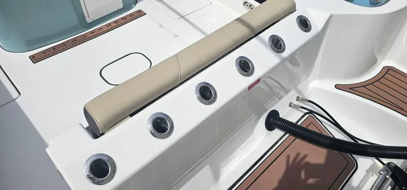  Yacht Photos Pics Tidewater 320 CC Adventure 2022 boat deck with rod holders and cushioned seating.