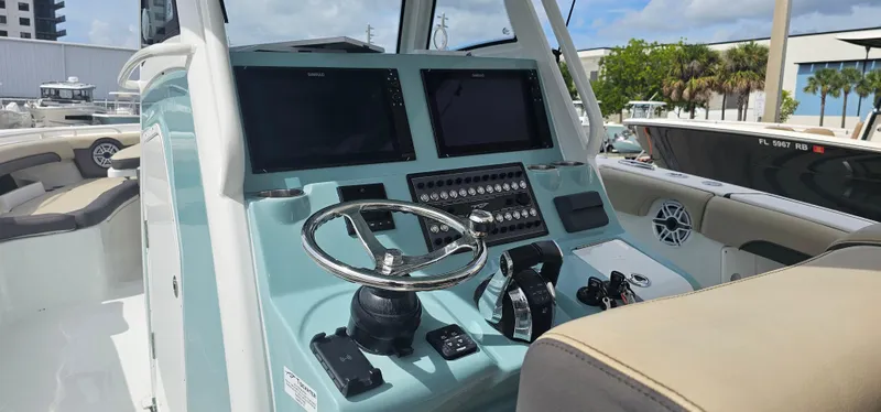  Yacht Photos Pics 2022 Tidewater 320 CC Adventure boat dashboard with steering wheel and control panels.