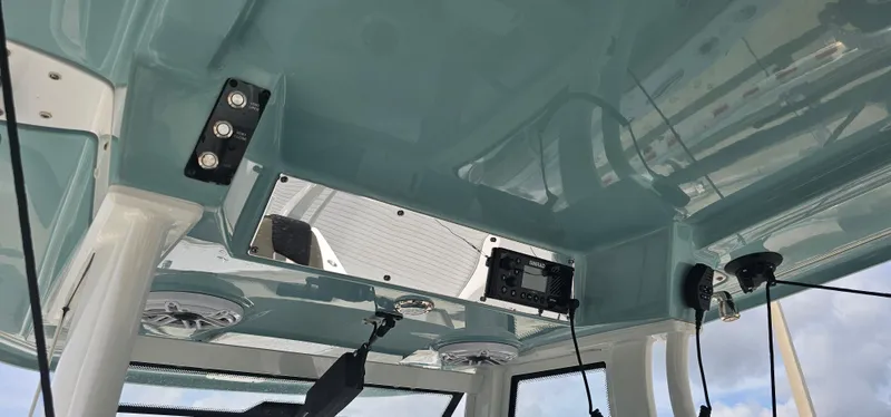  Yacht Photos Pics Interior view of 2022 Tidewater 320 CC Adventure boat's ceiling with speakers and electronics.