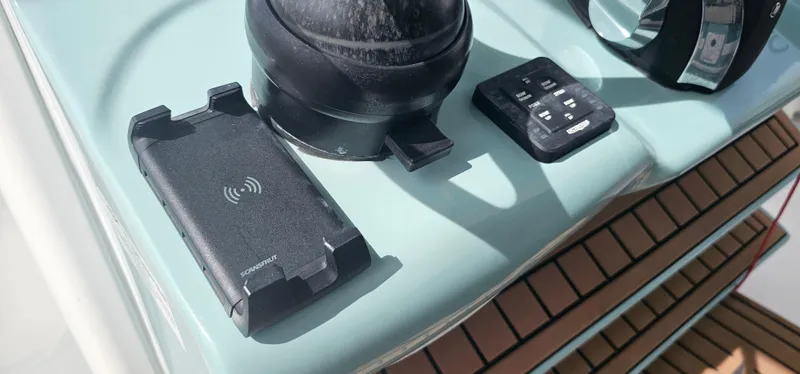  Yacht Photos Pics Tidewater 320 CC Adventure 2022 dashboard with wireless charger and remote control.