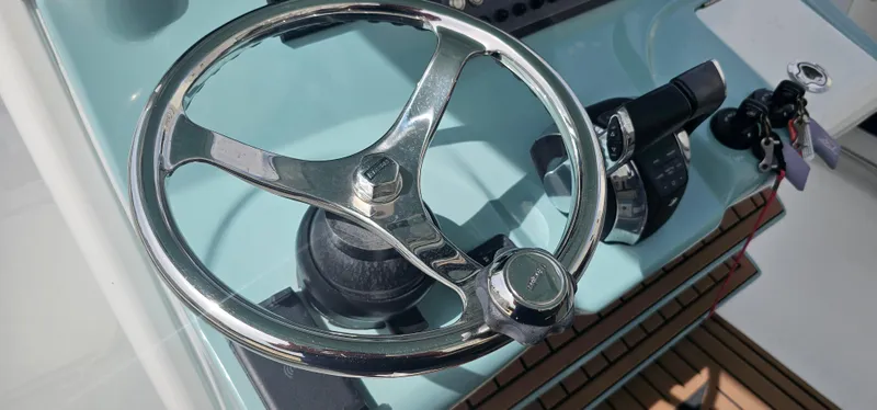  Yacht Photos Pics Steering wheel of 2022 Tidewater 320 CC Adventure boat, close-up view.