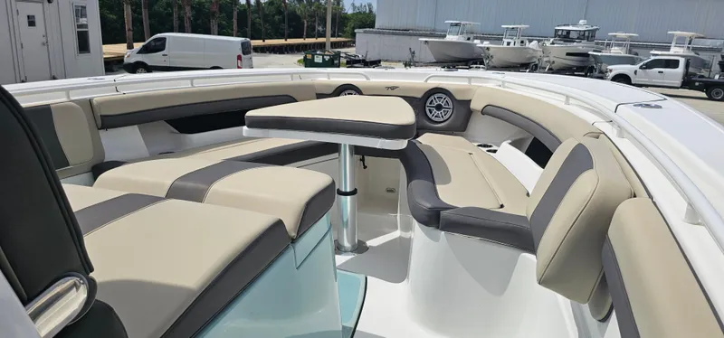  Yacht Photos Pics 2022 Tidewater 320 CC Adventure boat interior with beige seating and table.