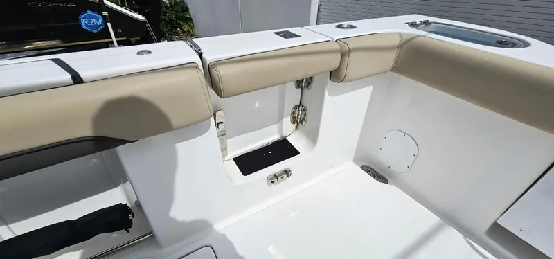  Yacht Photos Pics 2022 Tidewater 320 CC Adventure boat interior with beige seating and storage compartment.