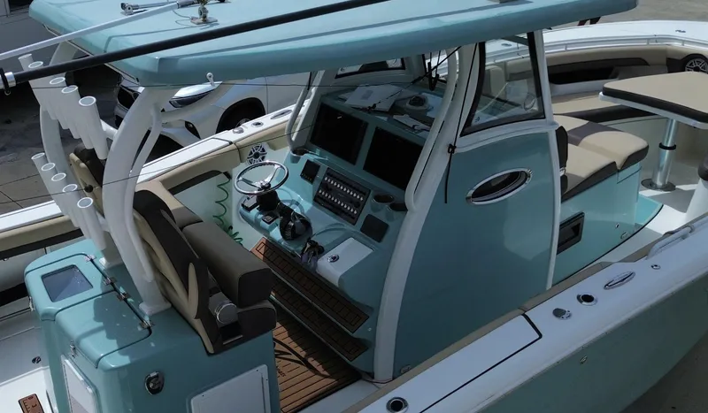  Yacht Photos Pics 2022 Tidewater 320 CC Adventure boat interior with helm and seating area.