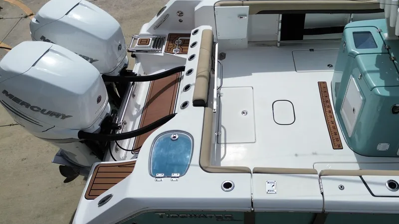  Yacht Photos Pics 2022 Tidewater 320 CC Adventure boat deck with twin Mercury engines.